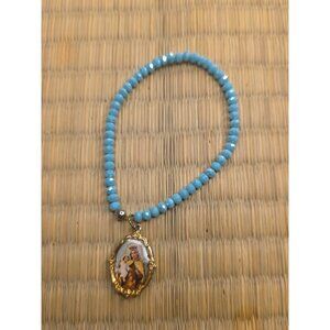 This is an aquamarine or light blue crystal Catholic rosary necklace or bracelet